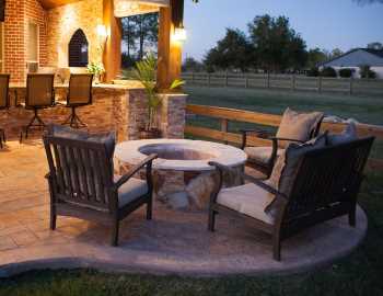 Outdoor Patio Seating Area Prosper TX featuring a professional outdoor design incorporating patio seating area with fire pit and outdoor kitchen in back yard.